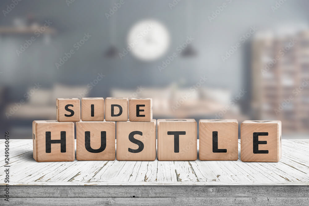 Side hustle sign on a plank table