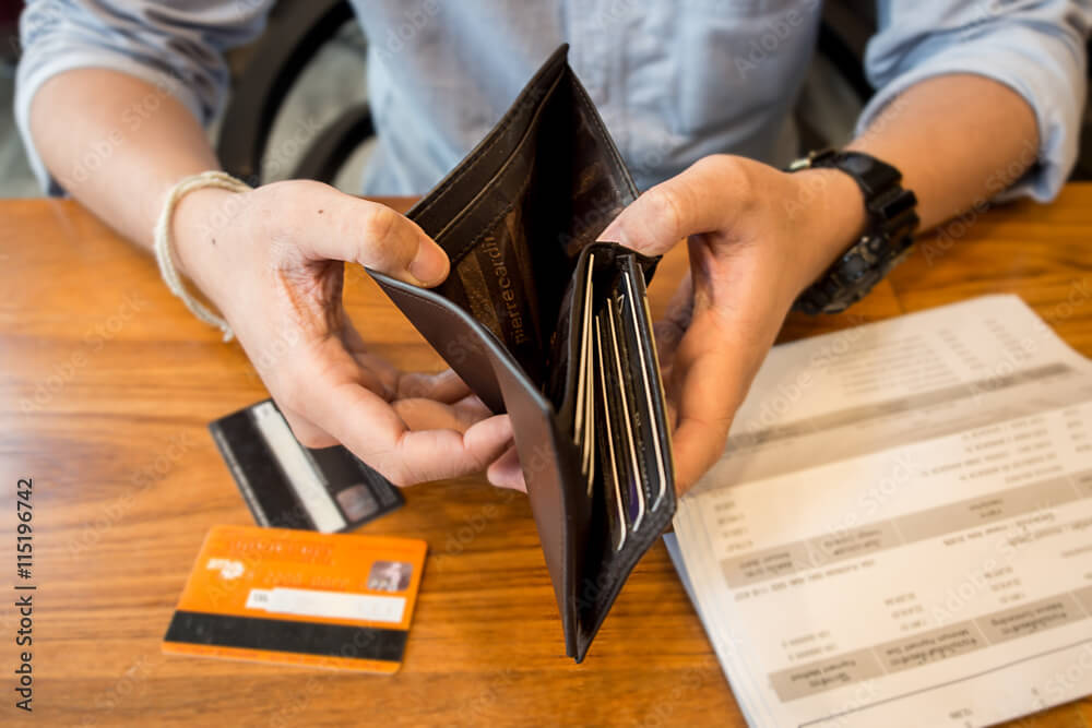 credit card debt - holding an empty wallet.